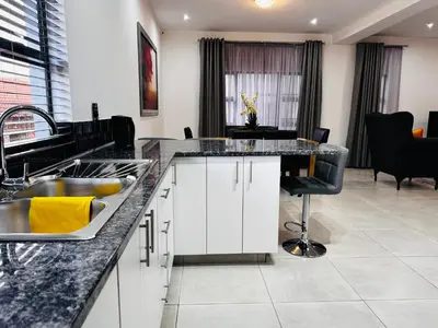 a kitchen with a sink and a counter at El-Gibbor Residence 1 in Ermelo