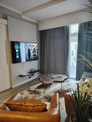 a living room with a couch and a table at Menlyn Maine Trilogy Apartment 519 in Pretoria