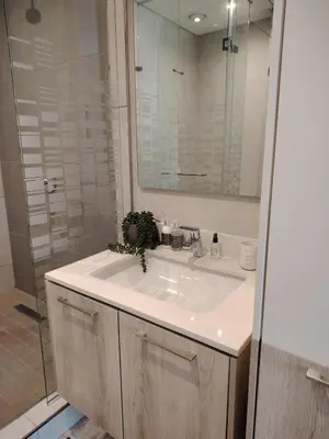 a bathroom with a white sink and a shower at Menlyn Maine Trilogy Apartment 519 in Pretoria