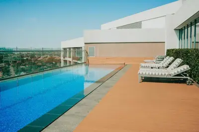 a swimming pool with lounge chairs next to a building at Menlyn Maine Trilogy Apartment 519 in Pretoria