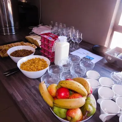 a table with a bowl of fruit and bowls of food at The Essence Resort in Clarence