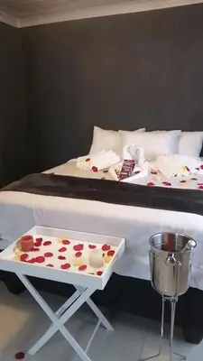 a bed with a tray of cupcakes on it at The Essence Resort in Clarence