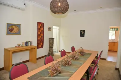 a conference room with a long table and chairs at The Hellens Guest House in Pretoria