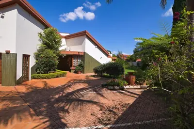 a house with a brick driveway in front of it at The Hellens Guest House in Pretoria