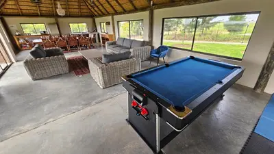 a pool table in the middle of a room at Die Pekanneut in Polokwane