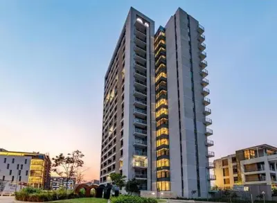a tall building with lights on in a city at Menlyn Maine Trilogy 1417 in Pretoria