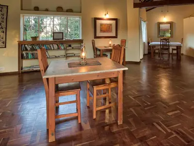 a dining room with a table and chairs in a room at Seringa Lodge & Safaris in White River