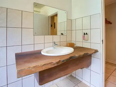 a bathroom with a sink and a mirror at Seringa Lodge & Safaris in White River