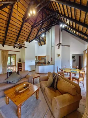 a living room with a couch and a table at Kruger Park Lodge 243 in Hazyview