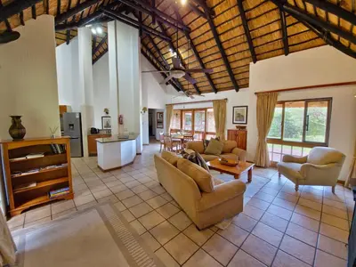 a large living room with couches and a table at Kruger Park Lodge 243 in Hazyview