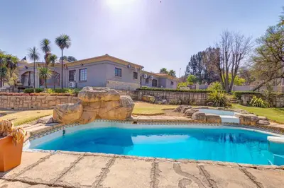 a swimming pool in front of a house at Aaybee Recreational Home in Midrand