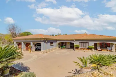 a large white house with a large driveway at Aaybee Recreational Home in Midrand