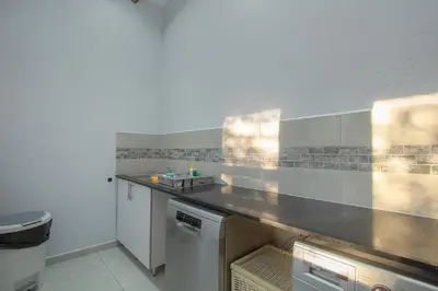 a kitchen with a sink and a counter top at The Bush House Kruger in Marloth Park