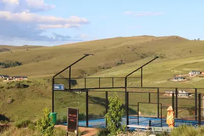 a swimming pool with a hill in the background at Highland Gate Golf & Trout Estate, House 910 in Dullstroom
