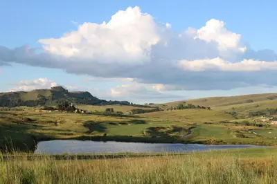 a view of a golf course with a pond at Highland Gate Golf & Trout Estate, House 910 in Dullstroom