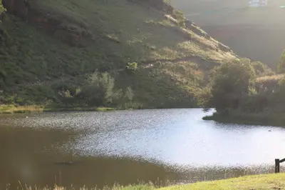 a lake in the middle of a mountain at Highland Gate Golf & Trout Estate, House 910 in Dullstroom