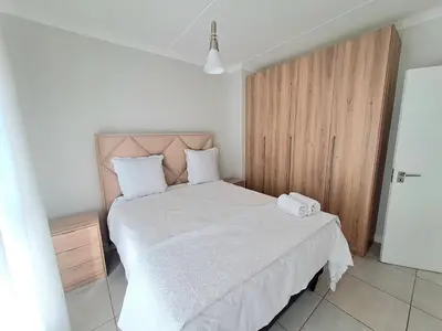 a bedroom with a bed with two towels on it at The Blyde Crystal Lagoon in Pretoria