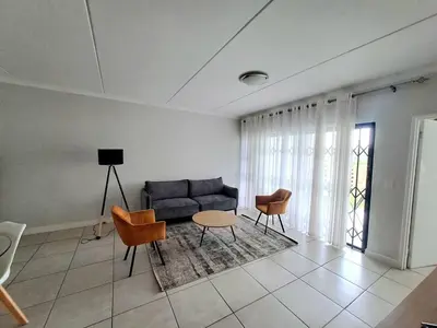 a living room with a couch and chairs and a table at The Blyde Crystal Lagoon in Pretoria
