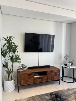a living room with a flat screen tv on a wall at 2411 Ellipse Waterfall in Midrand