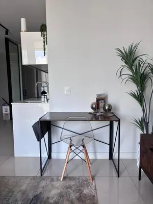 a black desk in a room with a white wall at 2411 Ellipse Waterfall in Midrand