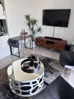 a living room with a tv and a coffee table at 2411 Ellipse Waterfall in Midrand