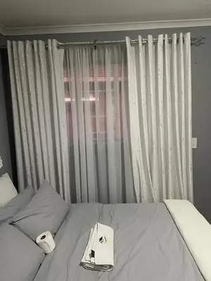 a bed with a hat and towels on top of it at Holiday apartment in Kempton Park