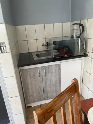 a small kitchen with a sink and a counter at Holiday apartment in Kempton Park