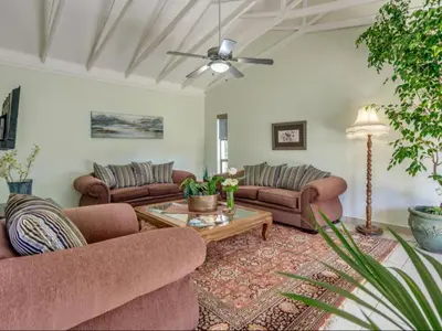 a living room with two couches and a coffee table at Jacobs Well Guest House in Centurion