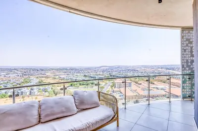 a living room with a couch and a view at Luxurious living Waterfall in Midrand