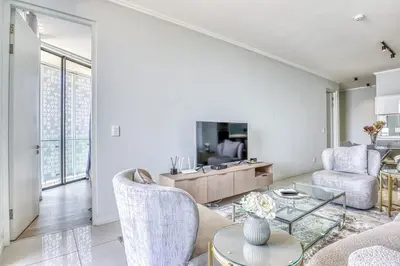 a living room with a couch and a table at Luxurious living Waterfall in Midrand
