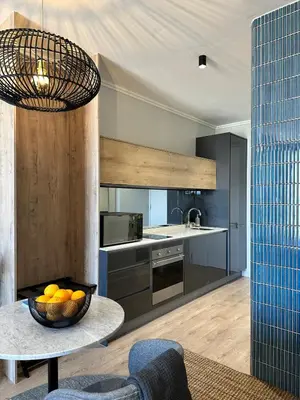 a kitchen with a bowl of oranges on a table at Explore Ellipse - Peacock Room in Midrand
