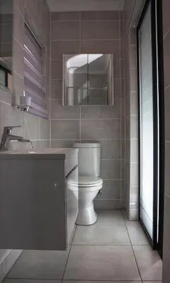 a bathroom with a toilet and a sink and a mirror at Serenity Stay at The Blyde River Walk Estate in Pretoria