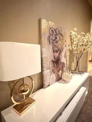 a table with a lamp and a picture on it at Haven on Glen in Johannesburg