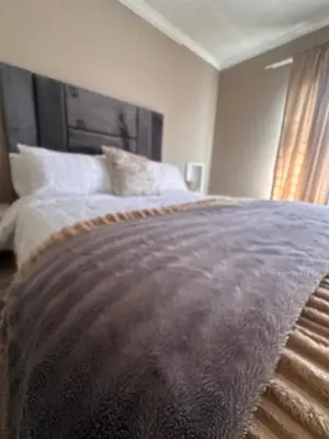 a bedroom with a bed with a blanket on it at Haven on Glen in Johannesburg