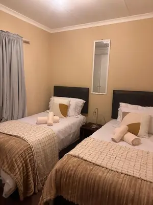 two beds sitting next to each other in a bedroom at Haven on Glen in Johannesburg