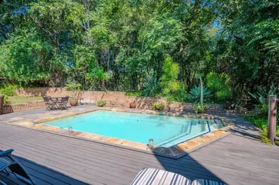 a swimming pool sitting on top of a wooden deck at Kruger Park Lodge Unit No 303 in Hazyview