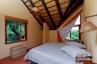 a bedroom with a large bed and a window at Verlorenkloof Estate in Wagenbietjieshoek