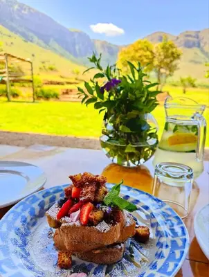 a plate of food with strawberries on a table at Verlorenkloof Estate in Wagenbietjieshoek