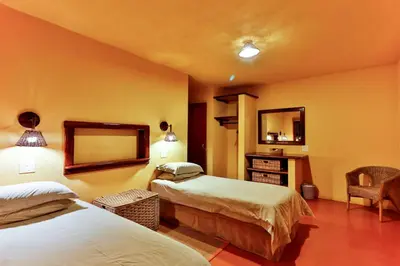 a hotel room with two beds and a mirror at Verlorenkloof Estate in Wagenbietjieshoek