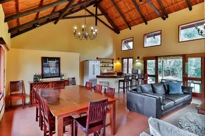 a living room with a table and a couch at Verlorenkloof Estate in Wagenbietjieshoek