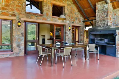 a dining room with a table and chairs at Verlorenkloof Estate in Wagenbietjieshoek