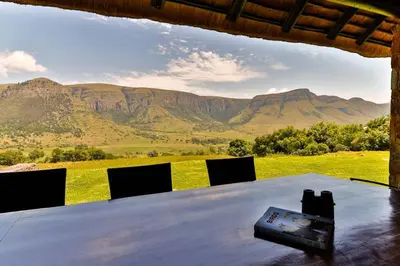 a table with chairs and a view of mountains at Verlorenkloof Estate in Wagenbietjieshoek