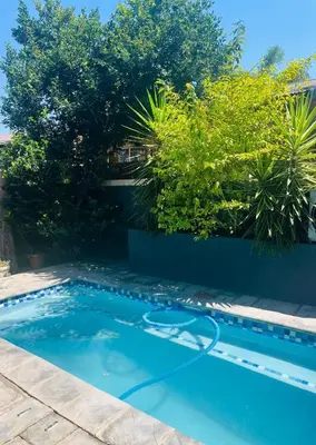 a swimming pool in a yard with a blue pool at 13 Orion Aparment in Polokwane