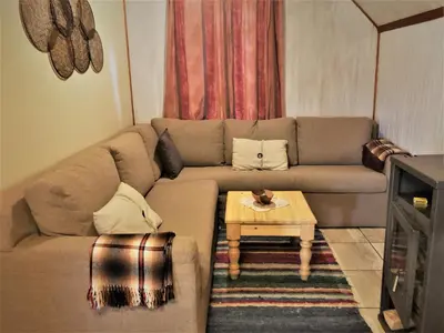 a living room with a couch and a coffee table at Zur Alten Mine in Graskop