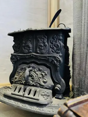a black fireplace with a grate in the middle at Clarkys Bucketlist Dullstroom in Dullstroom