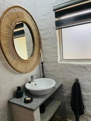 a bathroom with a sink and a mirror at Clarkys Bucketlist Dullstroom in Dullstroom