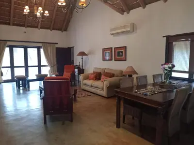 a living room with a couch and a table at Iphupho Bush Lodge, Ba-Phalaborwa Golf Estate in Phalaborwa