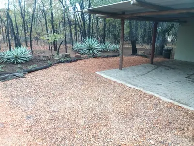a garden with a pavilion and some plants at Iphupho Bush Lodge, Ba-Phalaborwa Golf Estate in Phalaborwa