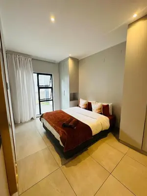 a bedroom with a bed and a large window at Next to Brooklyn Mall Cosy stay in Pretoria