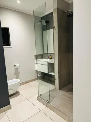a bathroom with a glass shower and a toilet at Next to Brooklyn Mall Cosy stay in Pretoria